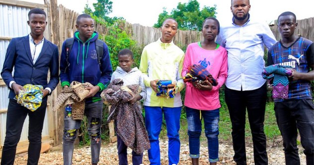 Children and young people in Uganda receiving clothing distributed by Hope Ineza Foundation