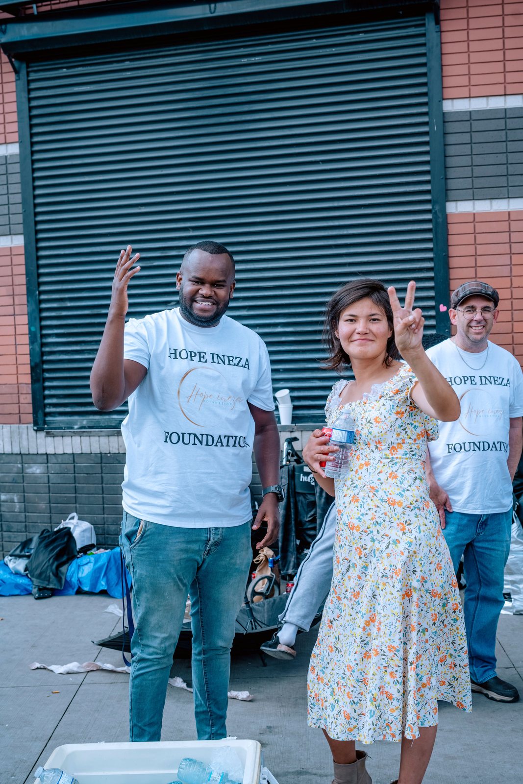 A Hope Ineza Foundation volunteer greeting someone during a street outreach