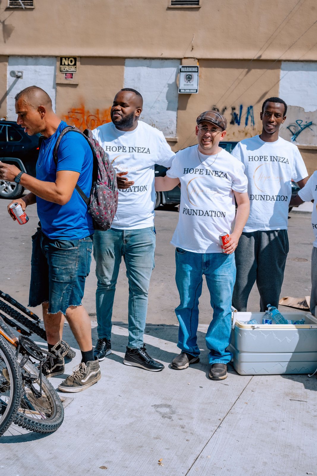 Volunteers standing with a man during a street outreach