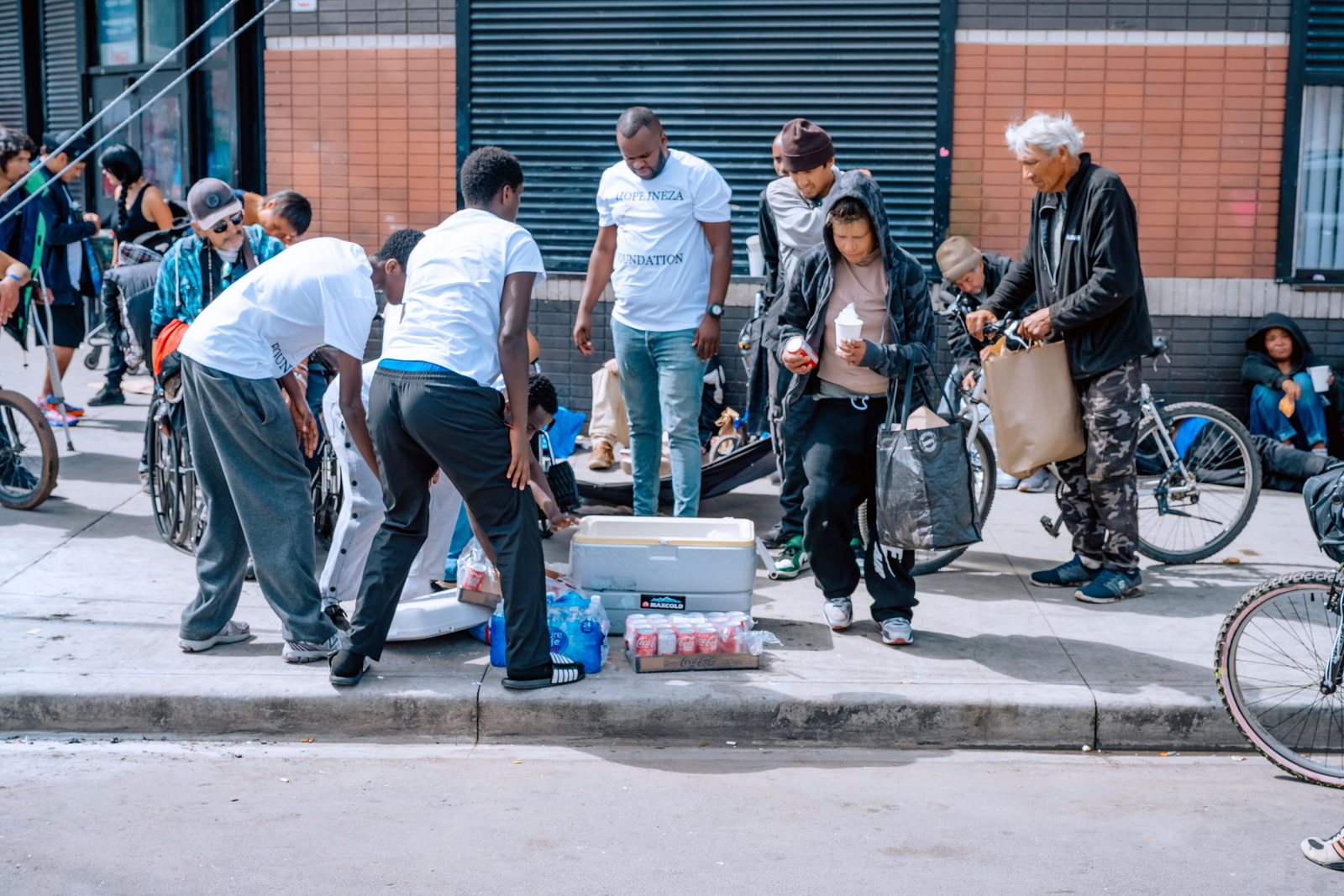 Volunteers unpacking supplies on the pavement during a street outreach