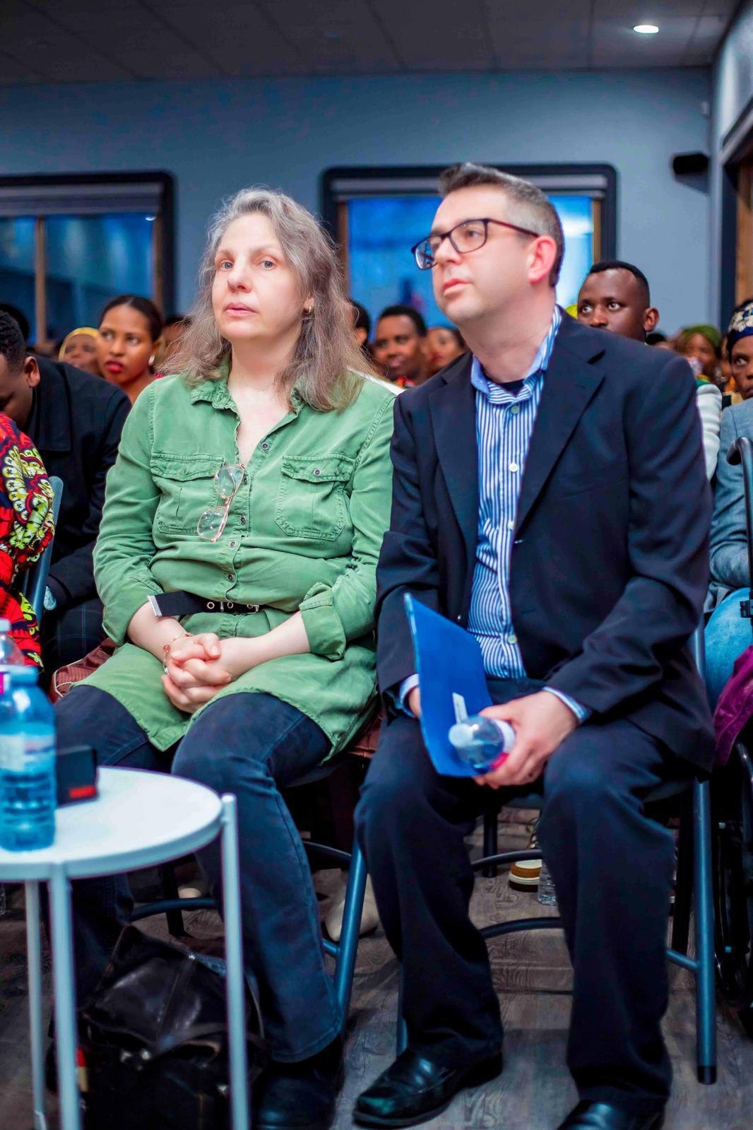 Two supporters seated in the audience at a Hope Ineza Foundation gathering