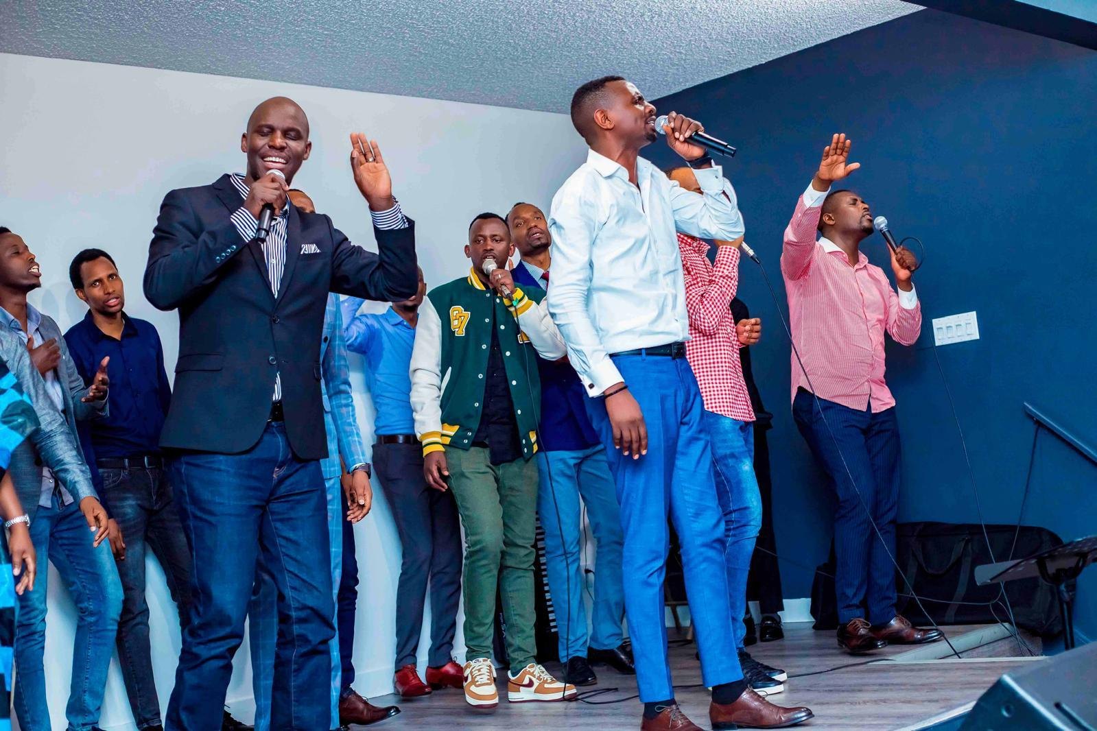A group of men singing together at a Hope Ineza Foundation community event